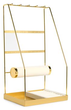 a gold and white paper dispenser on a white background