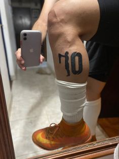 a man with a number tattoo on his leg