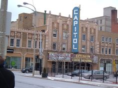 a blurry photo of an old building with a sign on it's side