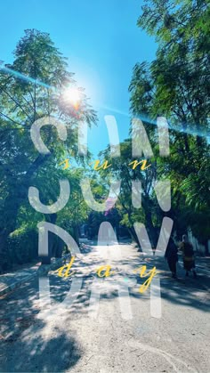 the sun is shining down on an empty road with trees and people walking along it