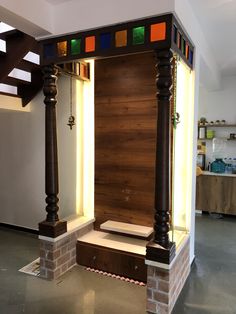 a wooden door with stained glass panels on the front and sides in a room that has stairs leading up to it