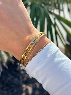 Stainless steel bangle accented with roman numeral cutouts all around. Roman numerals VI II VI VII II II VIII X VIII ( 6 2 6 7 2 2 8 10 8 ) -Material: 18k gold plated, triple plated, over stainless steel - water resistant/waterproof -Size: Best fit for size 7" wrist, approx. 0.25" thick -Closure: Side latch - pinch down on the ends and pull apart to open Stainless Steel Bangles, Pull Apart, Roman Numeral, Roman Numerals, Steel Water, 18k Gold, Gold Plate, Bangles, Water Resistant