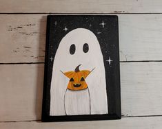 a painting of a ghost holding a jack - o - lantern on a white wooden background