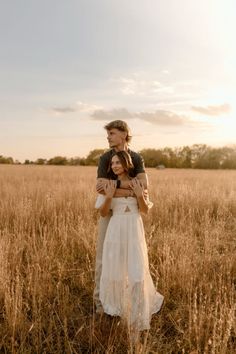 a man holding a woman in a field