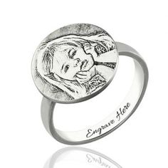 an engraved ring with a woman's face on the front and side, in silver