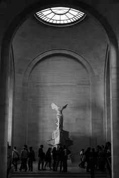 people are standing in front of the statue