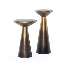 two black and gold pedestals sitting next to each other on a white background,