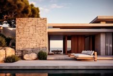 an outdoor lounge area next to a swimming pool and stone wall with sliding doors leading out onto the ocean