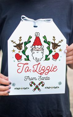 a person holding up a sign that says to liggie from santa