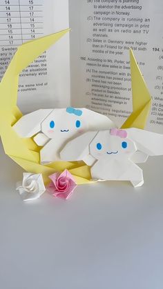 an origami crab with its baby in it's stomach and flowers on the side