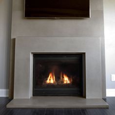 a fire place with a television above it