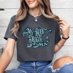 📚✨ "In My Book Dragon Era" Comfort Colors T-shirt - Cozy up with our adorable bookish dragon tee! ✨🐉 Show your love for all things bookish and dragons with our "In My Dragon Era" Comfort Colors T-shirt. This snuggle-worthy tee is not just about style; it's a celebration of literary magic and cozy comfort, perfect for embracing your inner book dragon. PRODUCT DETAILS Comfort Colors is the ultimate, comfy, oversized tee! Made with 100% with ring-spun cotton, This soft-washed, garment-dyed fabric Bestie Gifts, Book Dragon, High Fantasy, Comfort Colors Tee, Dyed Fabric, Oversized Tee, Book Lovers Gifts, Tshirt Colors, To Color