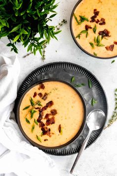 two bowls filled with soup on top of a table