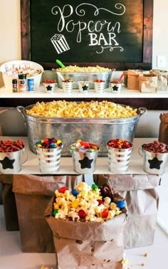 popcorn bar with buckets filled with different types of candy and candies on the table