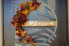 a door with a wreath on it that says,'closed'and is decorated with autumn leaves