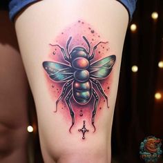 a woman's thigh with a tattoo design on it and a bee in the center