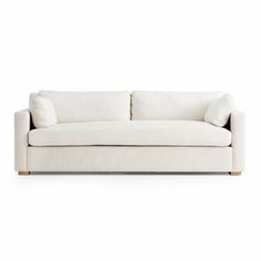 a white couch with two pillows on it