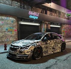 a car parked in front of a building with graffiti on it