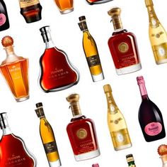 many bottles of different types of alcohol on a white background