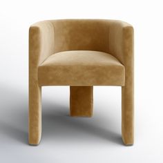 a beige chair sitting on top of a white floor