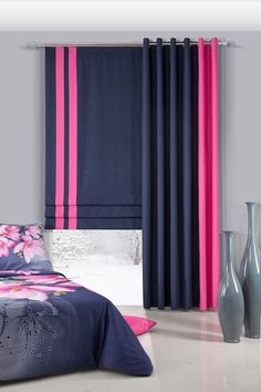 a bedroom with pink and blue curtains, vases and bed in the foreground