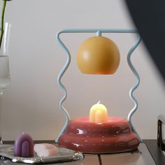 a table with a vase and candle on it