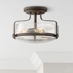 a light fixture in a room with white walls