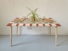 a table with two plates and a plant on it