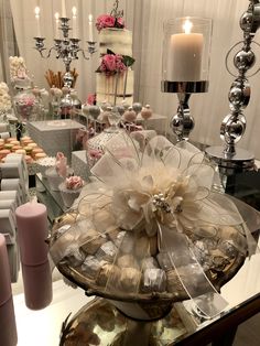 a table topped with lots of cakes and cupcakes