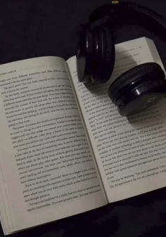 an open book with headphones on top of it