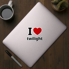 i love twilight sticker on a table next to a cup of coffee and pen