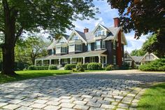 a large brick driveway in front of a house