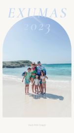 a group of people standing on top of a sandy beach next to the ocean in front of an arch