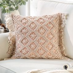 a crocheted pillow sitting on top of a white couch