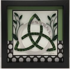 an intricate paper art piece with circles and leaves