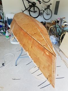 an upside down wooden boat in a garage