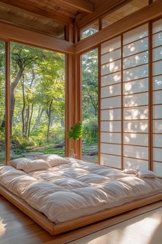 a large bed sitting inside of a bedroom next to a wooden window sill with lots of windows