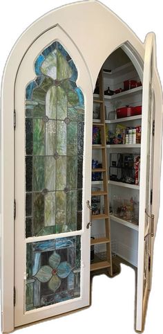 an open door with a stained glass window in the center and shelves behind it to store items