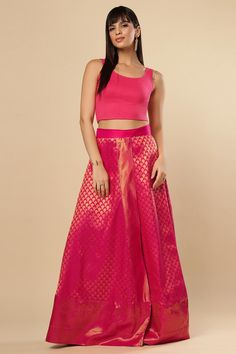 Pretty in Pink! A beautiful wrap around skirt that is made from silk with gold zari. The Gauri Pink Saree Skirt is your answer for casual ethnic appeal. The skirt is wrap around so where it with ease and share it with sisters! The length is ankle length but may be customized as per your preference. Product Features: Color: Pink Fabric: Silk Work: Zari Occasion: Festivewear Product Type: Saree Skirt Disclaimer: There will be slight difference in digital to actual image, props displayed on models Raw Silk Sharara With Tilla Embroidery, Traditional Zari Work Tiered Skirt Sets, Diwali Tiered Skirt Sharara With Zari Work, Diwali Sharara With Zari Work And Tiered Skirt, Traditional Navratri Tiered Skirt Set, Traditional Navratri Sets With Tiered Skirt, Bollywood Style Choli With Zari Work And Tiered Skirt, Traditional Tiered Sharara For Diwali, Diwali Choli With Long Skirt And Self Design