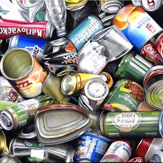 a pile of cans and cans with lids on them