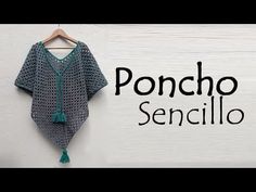 a crocheted shirt hanging on a wall with the words poncho sendillo