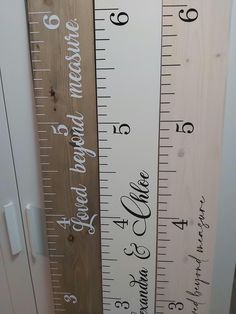 three wooden rulers with the names of two different cities on them, one is taller than the other