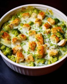 broccoli and chicken casserole in a white dish on a black surface