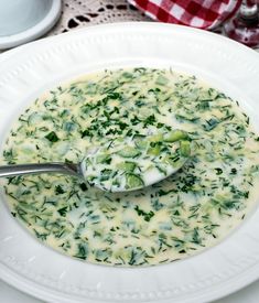 a white bowl filled with broccoli and cheese