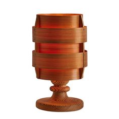 a wooden table lamp that is shaped like a stack of stacked plates on top of each other