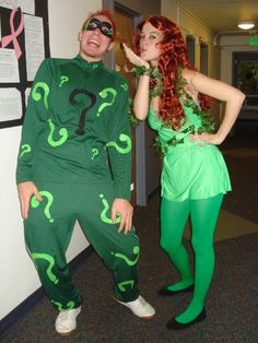 two people dressed up as riddle and the person in green are standing next to each other