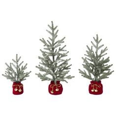 three small christmas trees with red bags on them