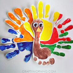 a handprint turkey made out of paper and painted with different colors on it's feathers