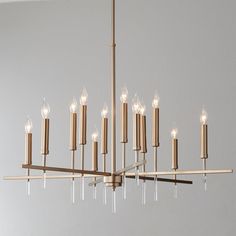 a chandelier with many lit candles hanging from it