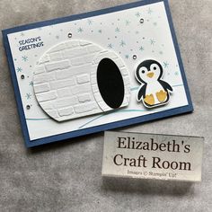 a penguin is standing in front of a craft room sign with a stamp on it